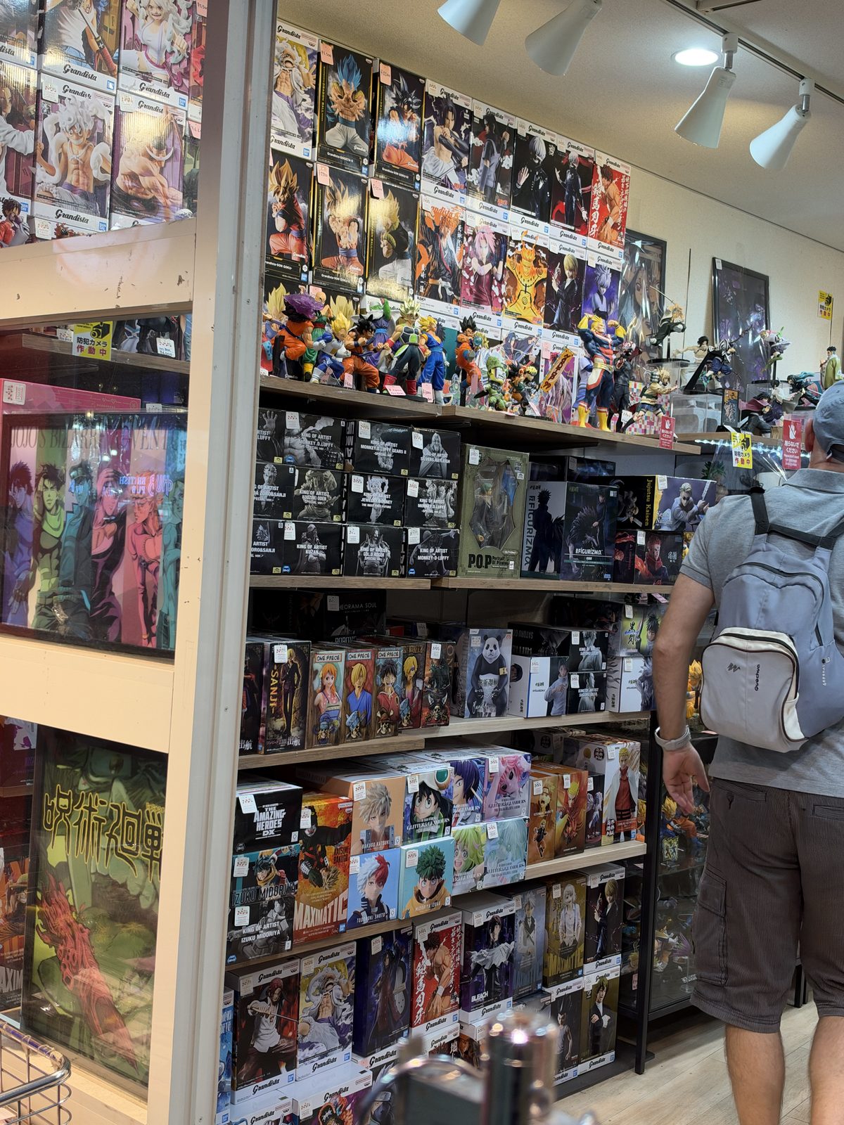 Shelves of boxed figures in a character goods shop, photographed in October 2026.
